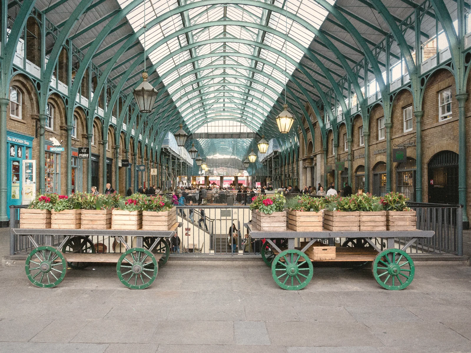 The glass-roofed market hall at Covent Garden with old flower carts