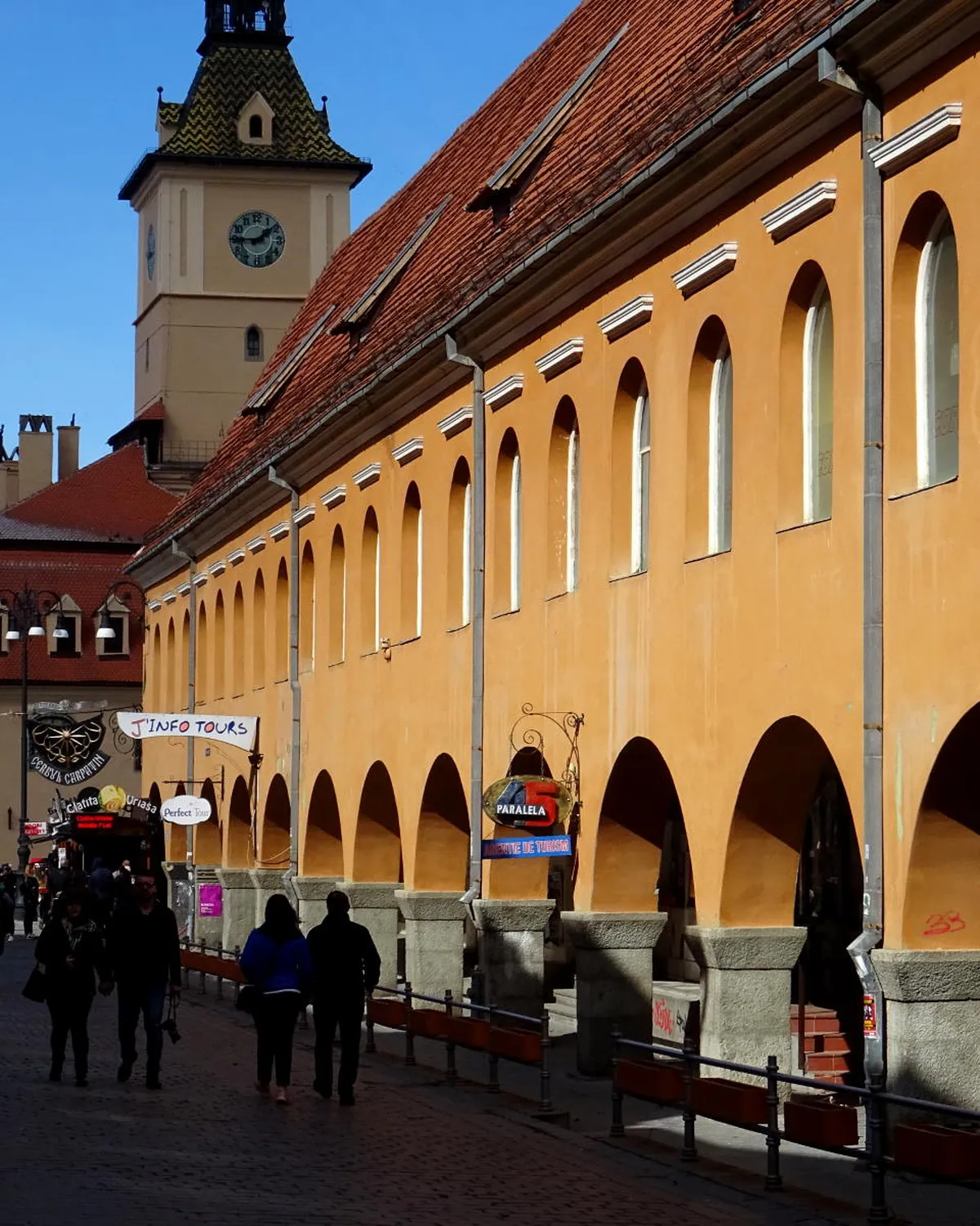 The arcaded Hirscher House on Brașov's main square, with the Council House tower behind