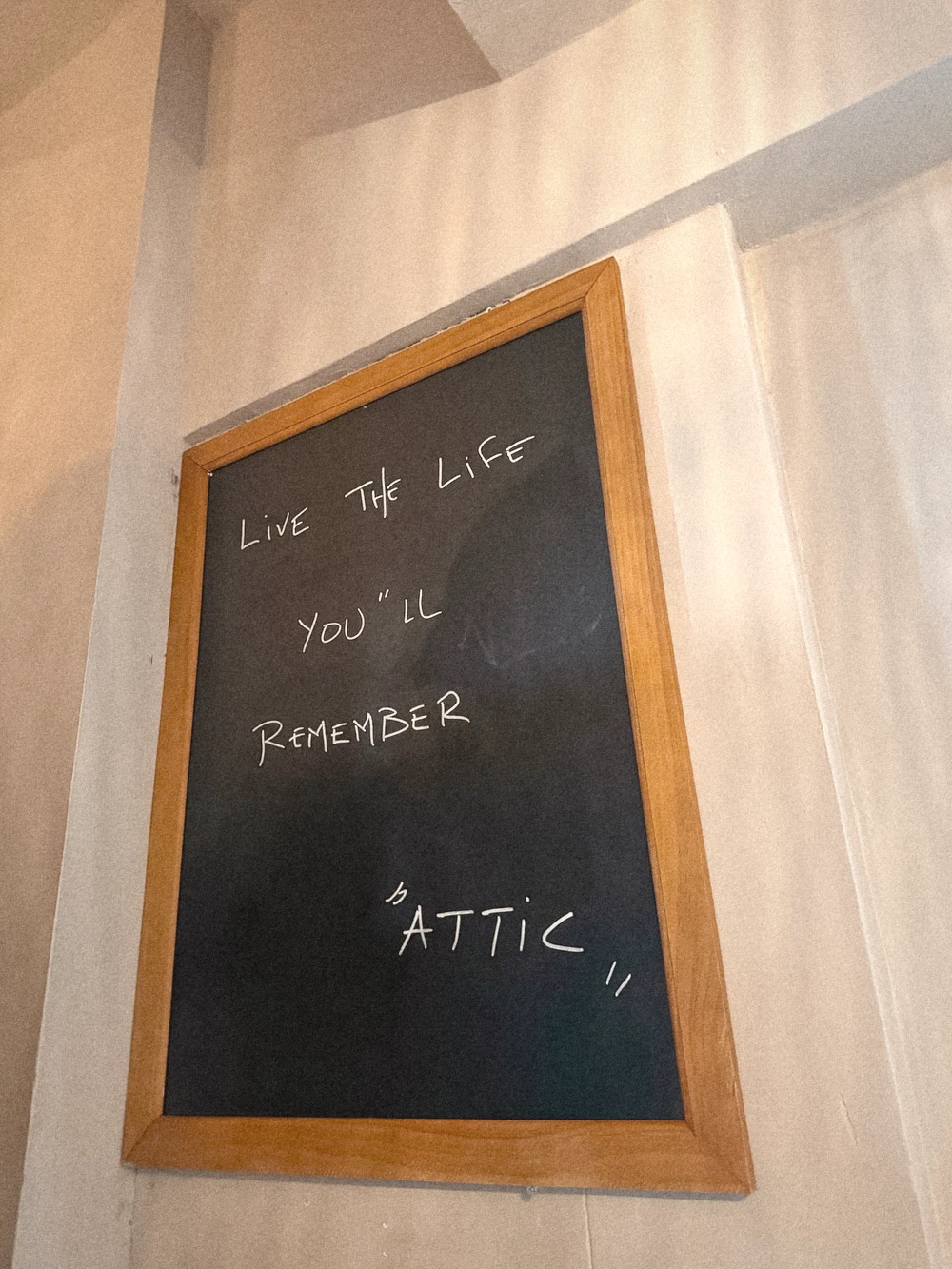 A chalkboard reading Live the life you'll remember, Attic