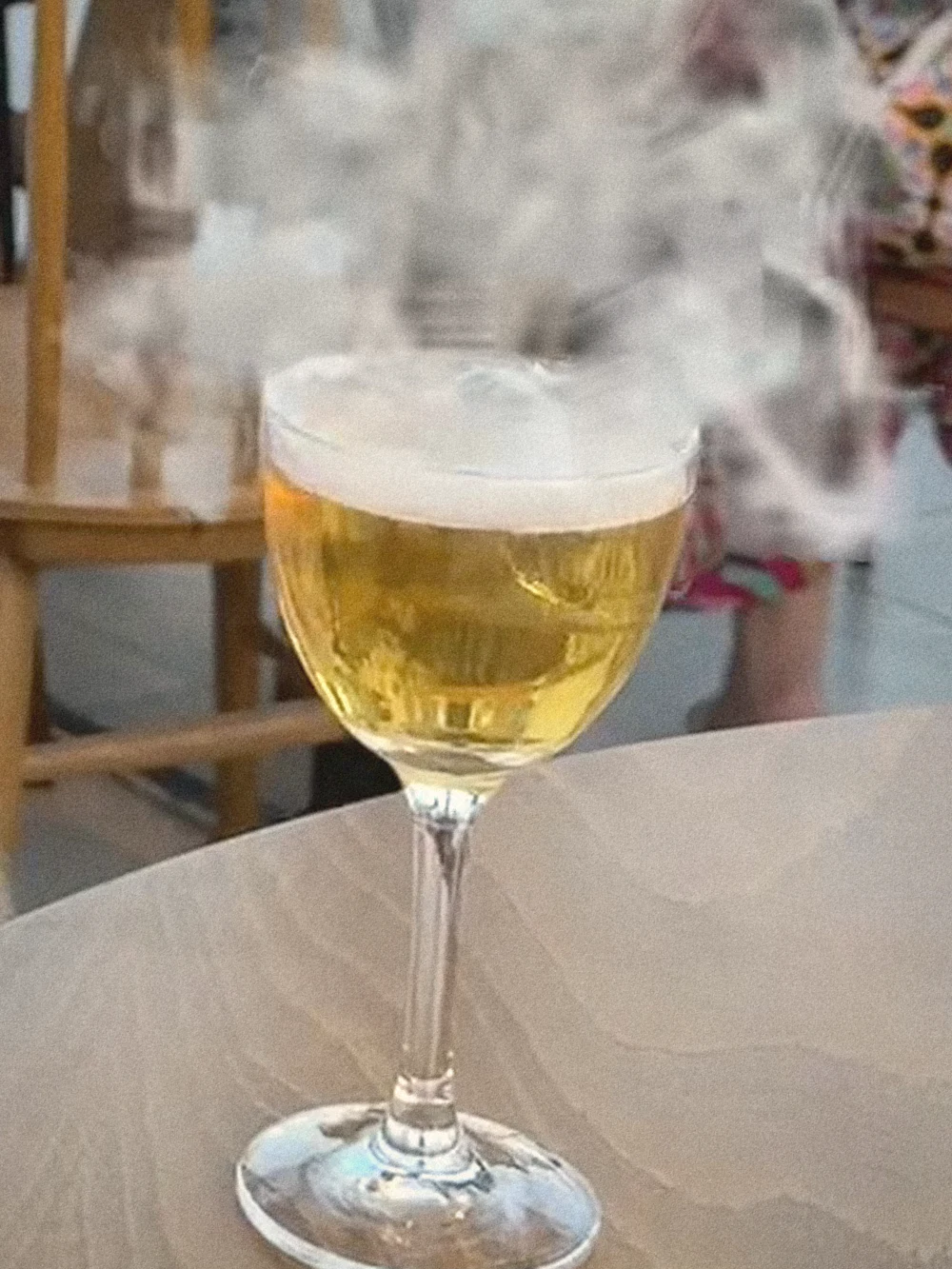 Coffee smoke drifting off the Gnosis cocktail in a stemmed glass