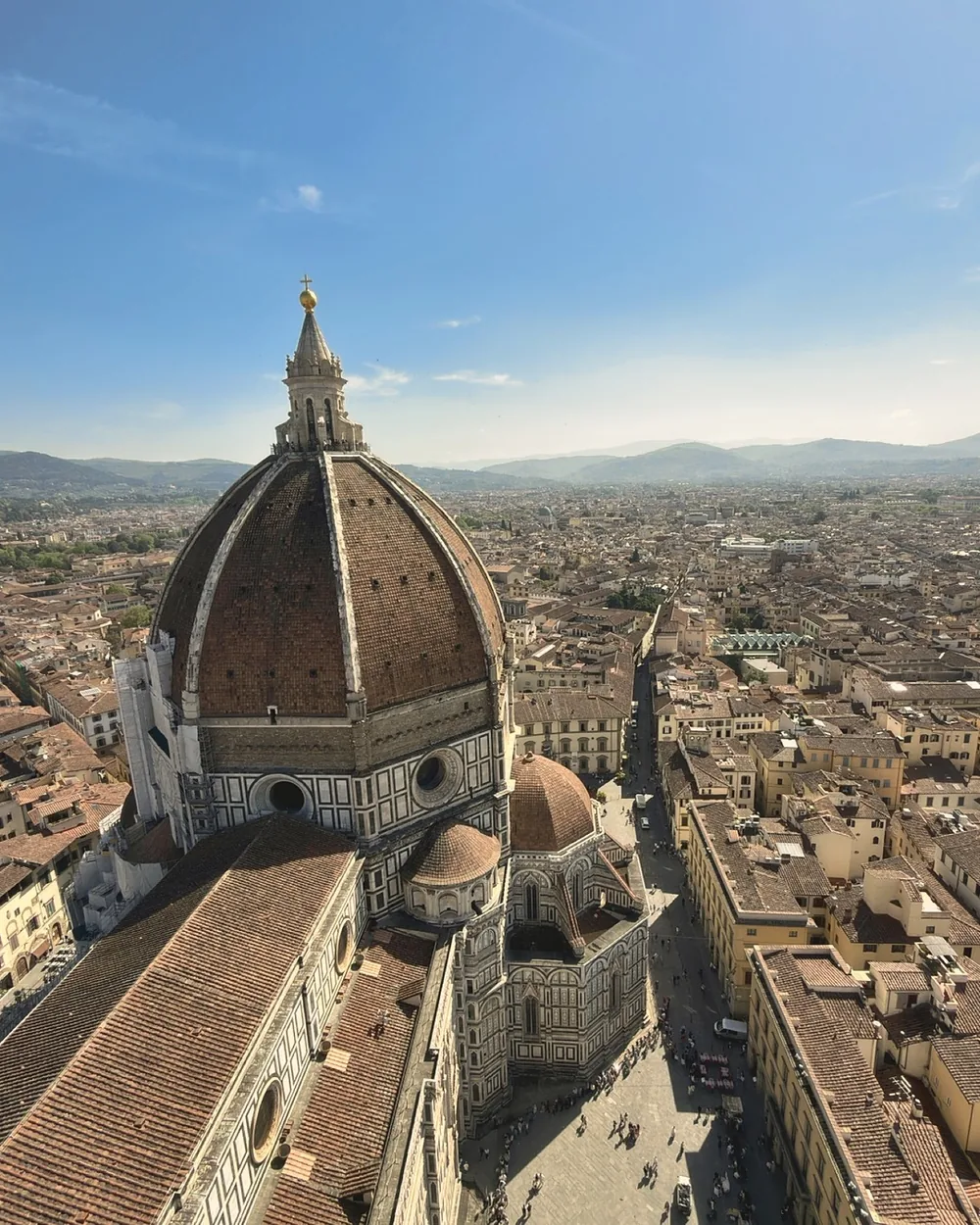 Brunelleschi's dome and the cathedral roof seen from the top of Giotto's bell tower, with Florence and the hills beyond