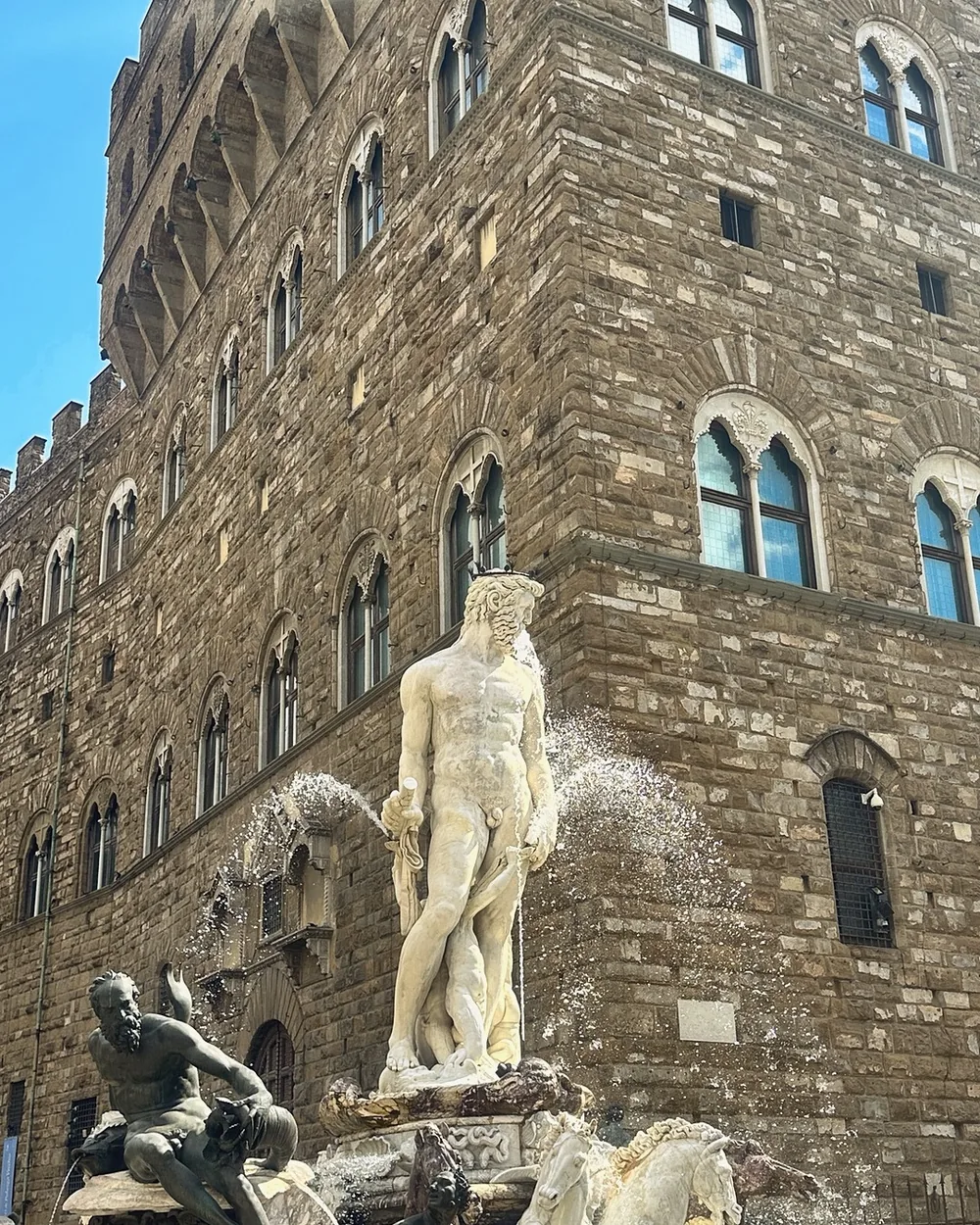 The marble Fountain of Neptune and its bronze figures in front of Palazzo Vecchio on Piazza della Signoria