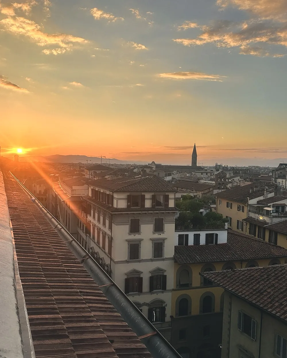 The sun setting over Florence's terracotta rooftops seen from the terrace