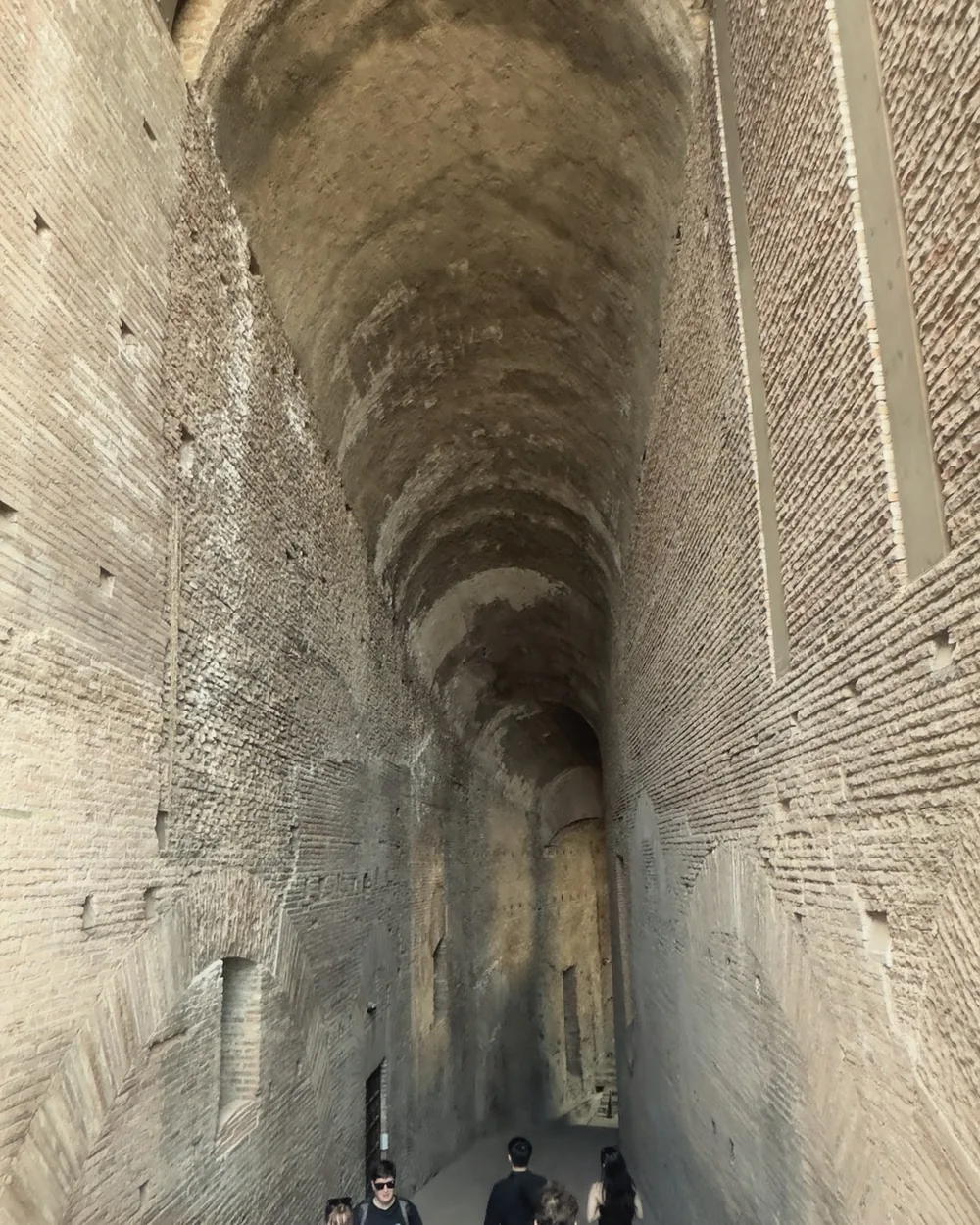 A vaulted stone corridor inside the Colosseum