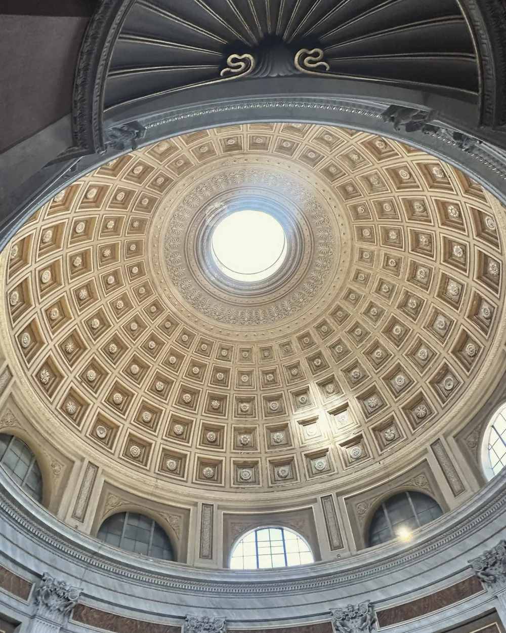 The coffered dome of the Sala Rotonda in the Vatican Museums with light from the oculus